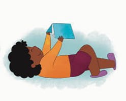 Child lying down reading a book
